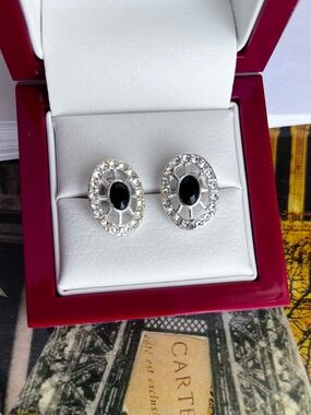Silver earrings featuring a central jet black stone & clear crystal rhinestones.